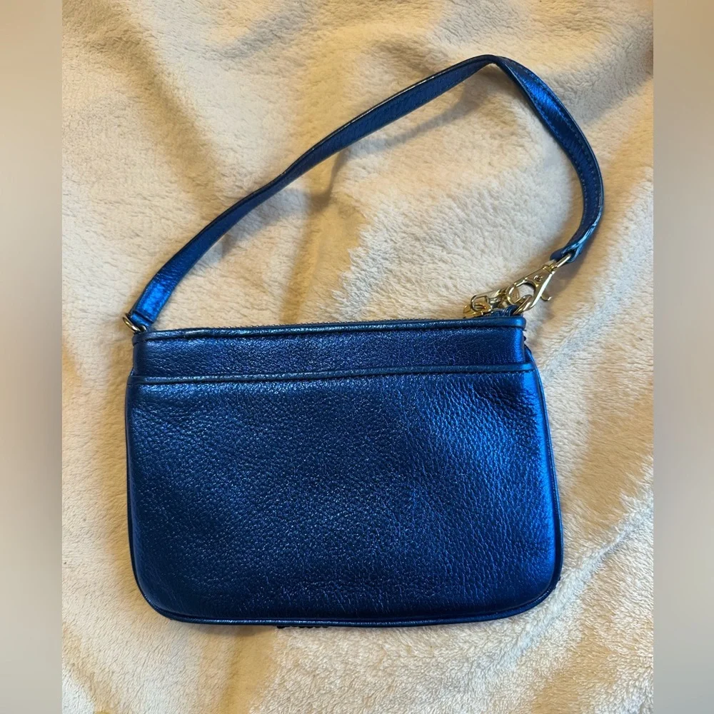 Michael Kors sapphire blue sequined wristlet with gold colored hardware.